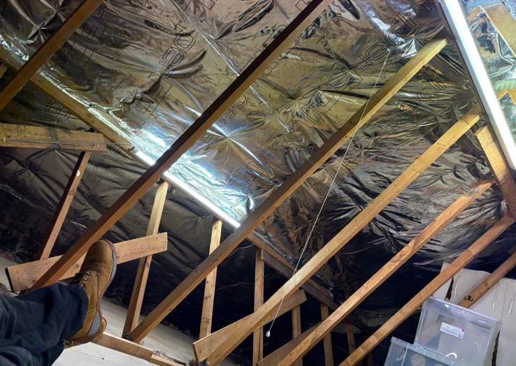 The same roof slope after our team fitted reflective super foil (multifoil) insulation neatly between the rafters