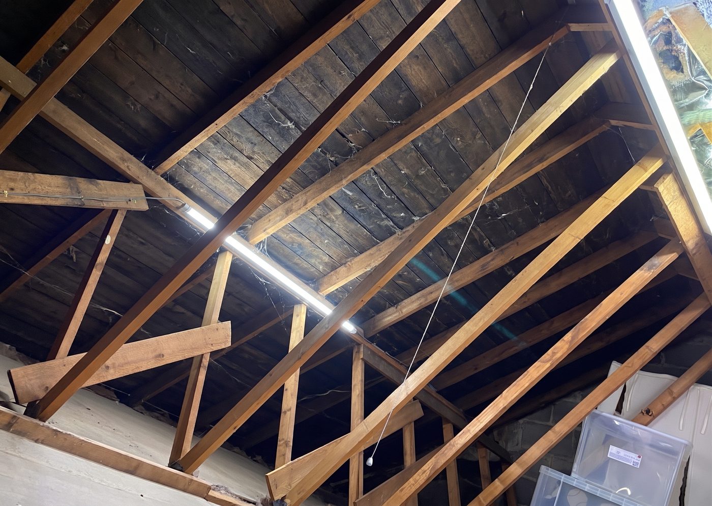 Walsall roof space before insulation — bare rafters at the roof slope with no foil or cover in place