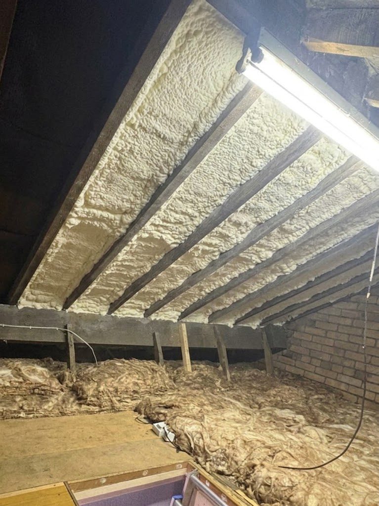Walsall loft with soft white open cell spray foam sprayed over the rafters, hiding the roof timbers